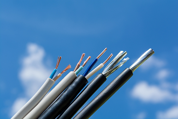 various stripped wires against the sky and clouds