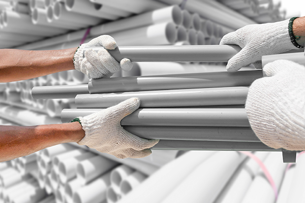 Plumber choose PVC pipes from bundle